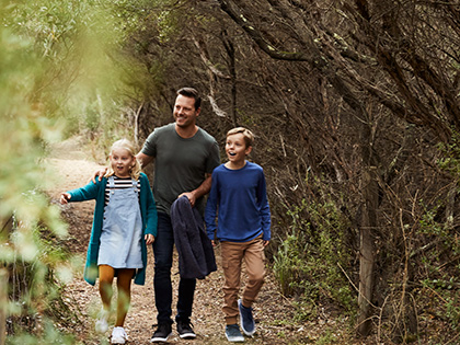 Parent and two kids walking on a bushland trail near RACV Inverloch Resort.