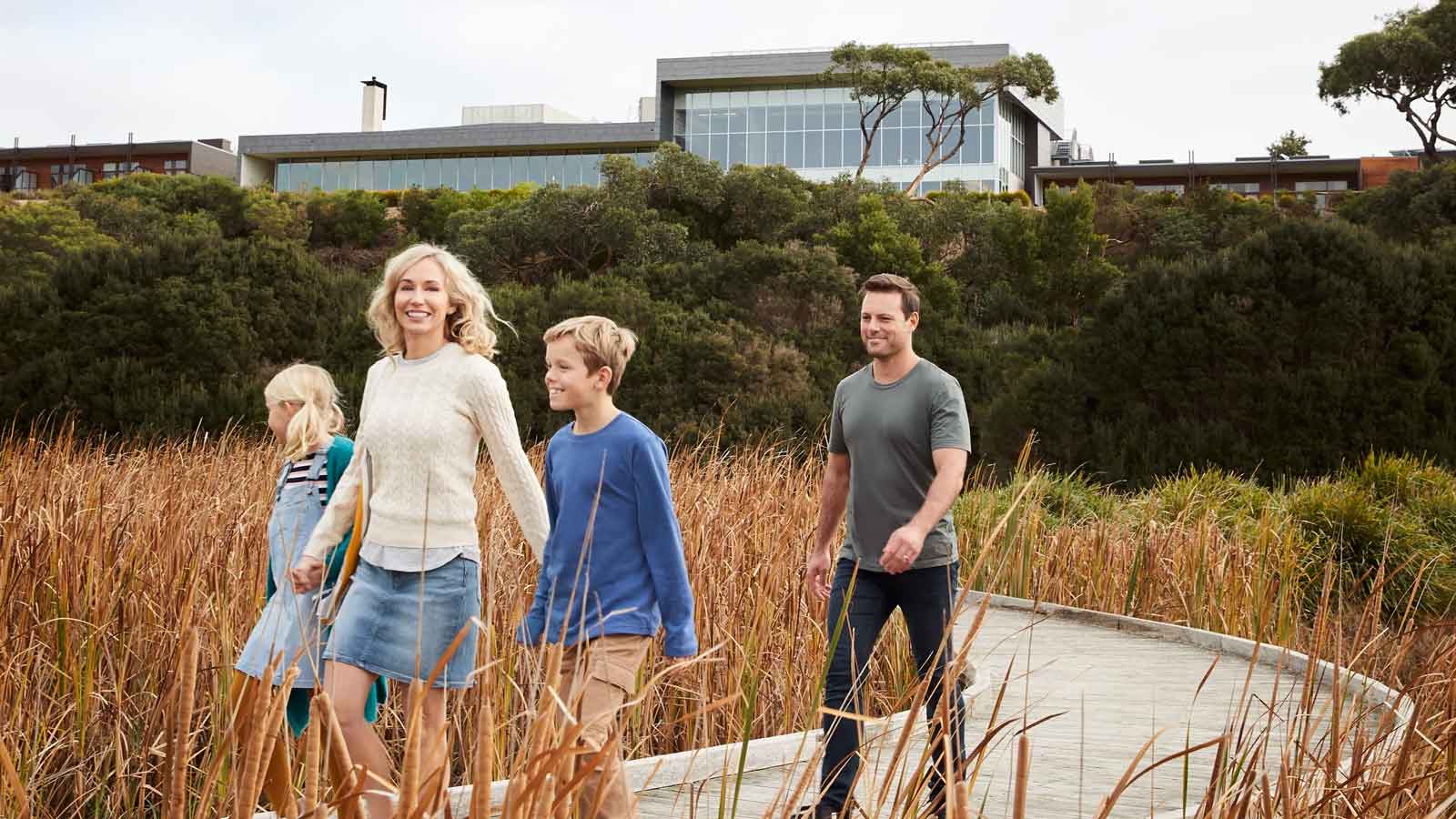Young family walking outside of the Inverloch resort. 