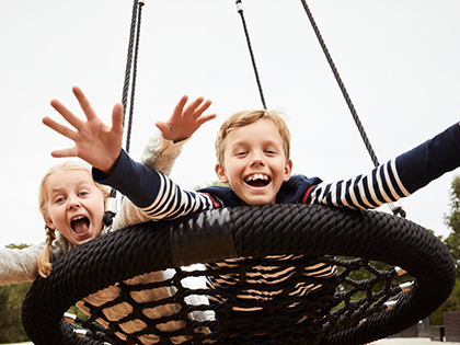Children on playground swing at RACV Inverloch Resort.