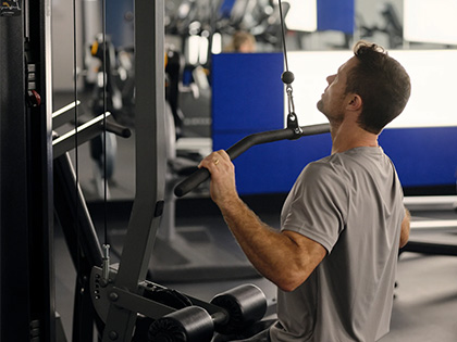 Man using the Lat pull down machine