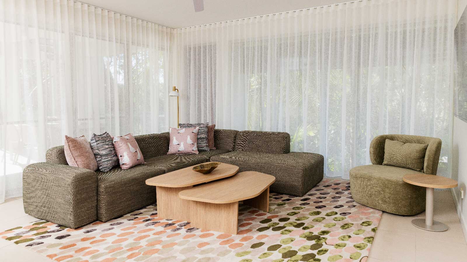 A living area with a plush couch in one of the Noosa accommodation suites.