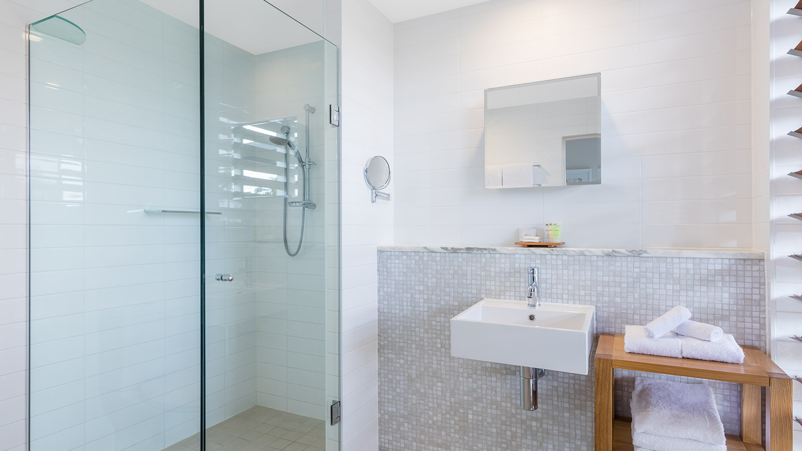 Modern sanctuary apartment bathroom at RACV Noosa Resort, with shower, sink and mirror. 