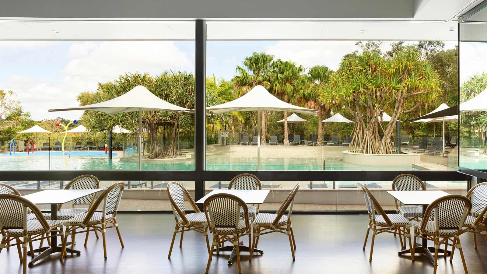 Dining area set up near outdoor pool at RACV Noosa Resort.
