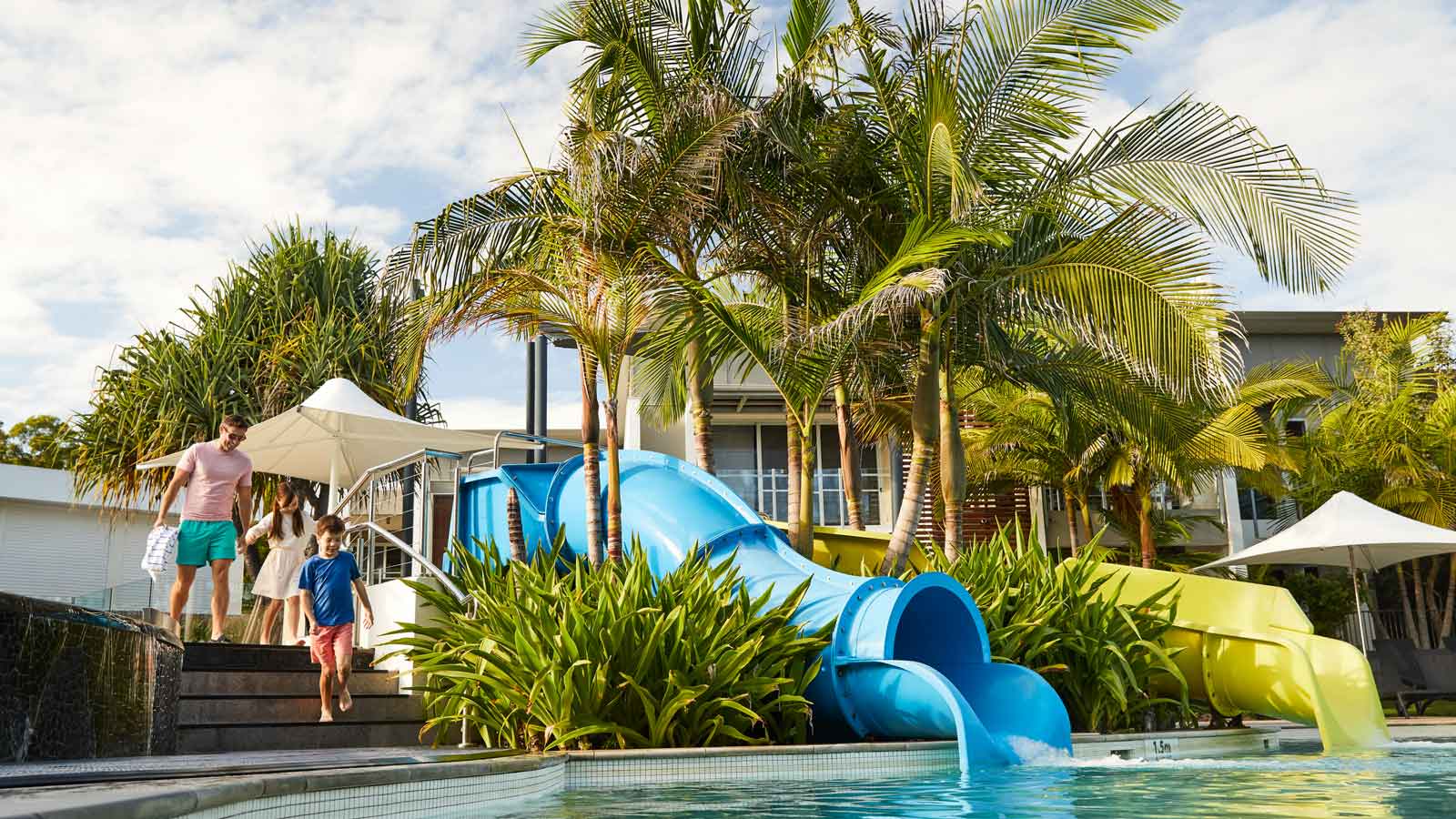 Family walking towards the pool at RACV Noosa Resort