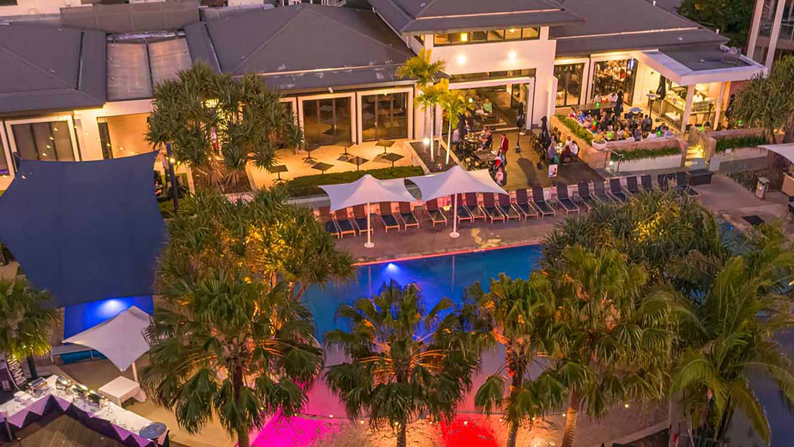 Aerial view of RACV Noosa Resort poolside at twilight.