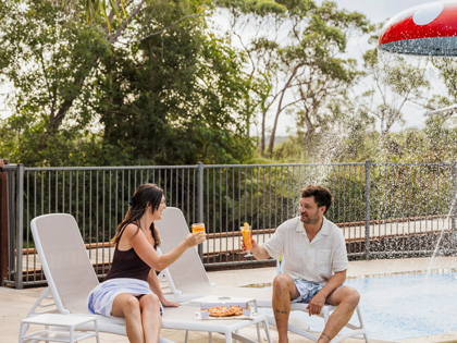 Couple toasting by the pool