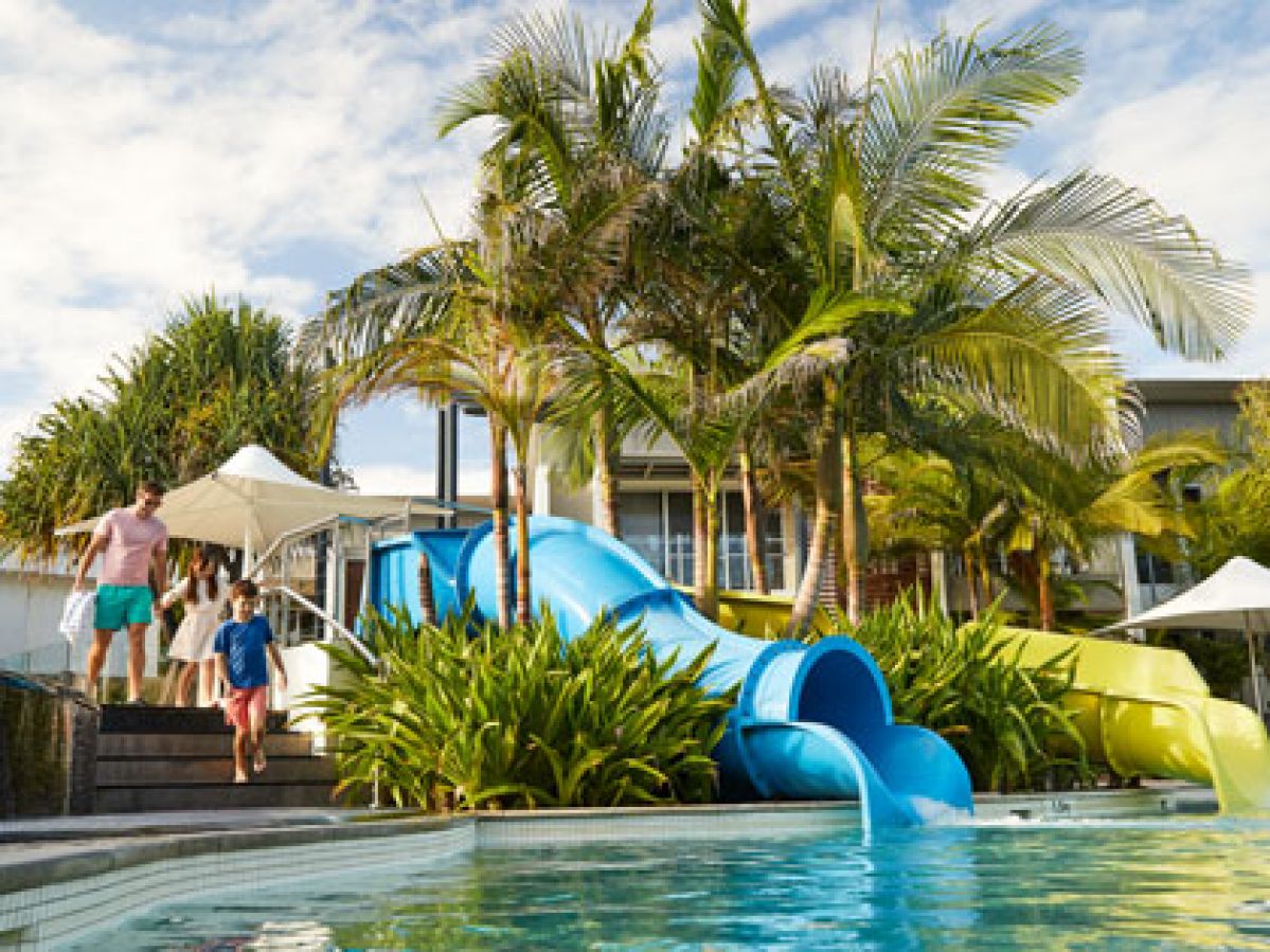 Family walking towards the pool at RACV Noosa Resort.