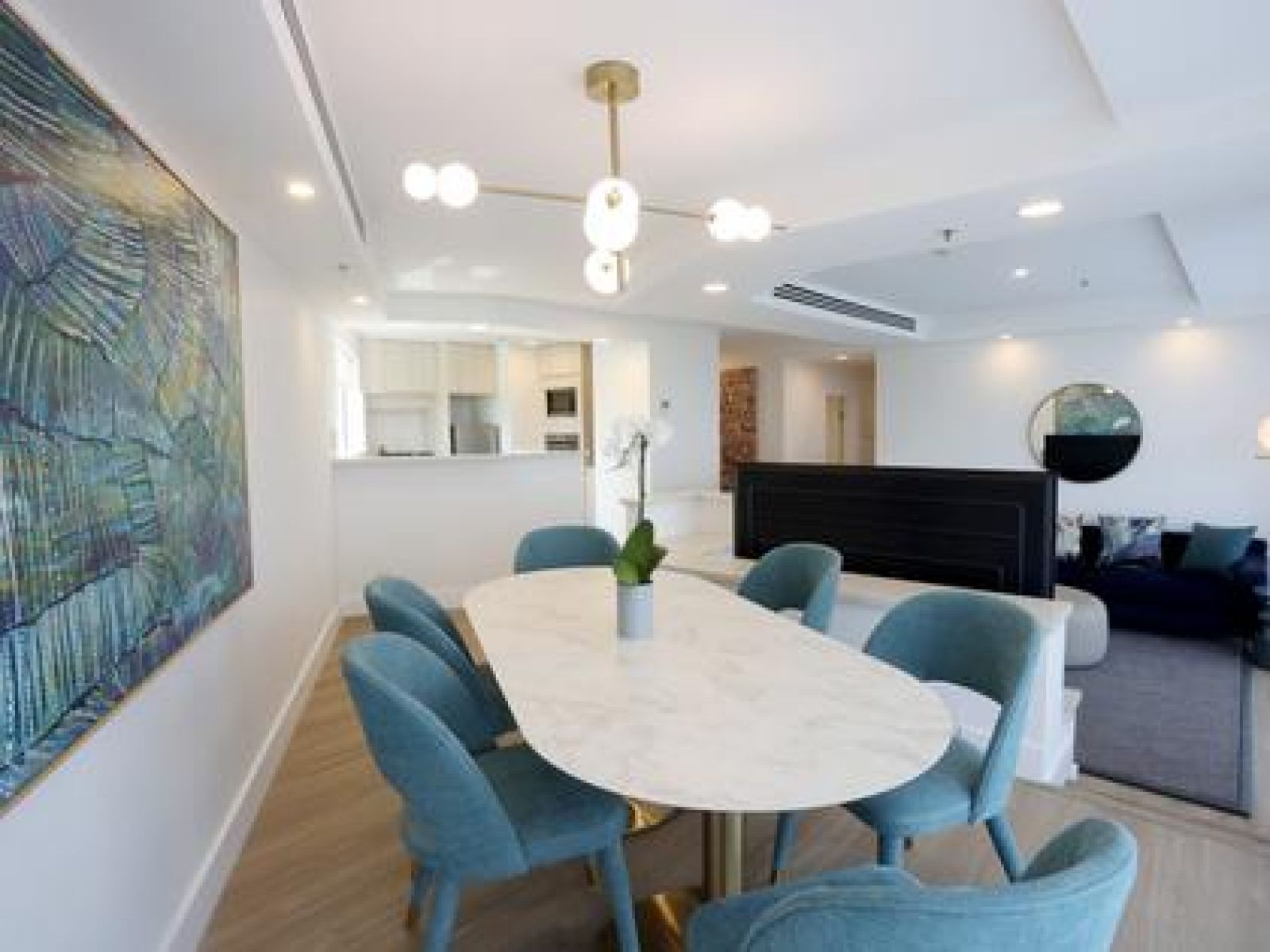 Dining table and blue chairs in a hotel suite.