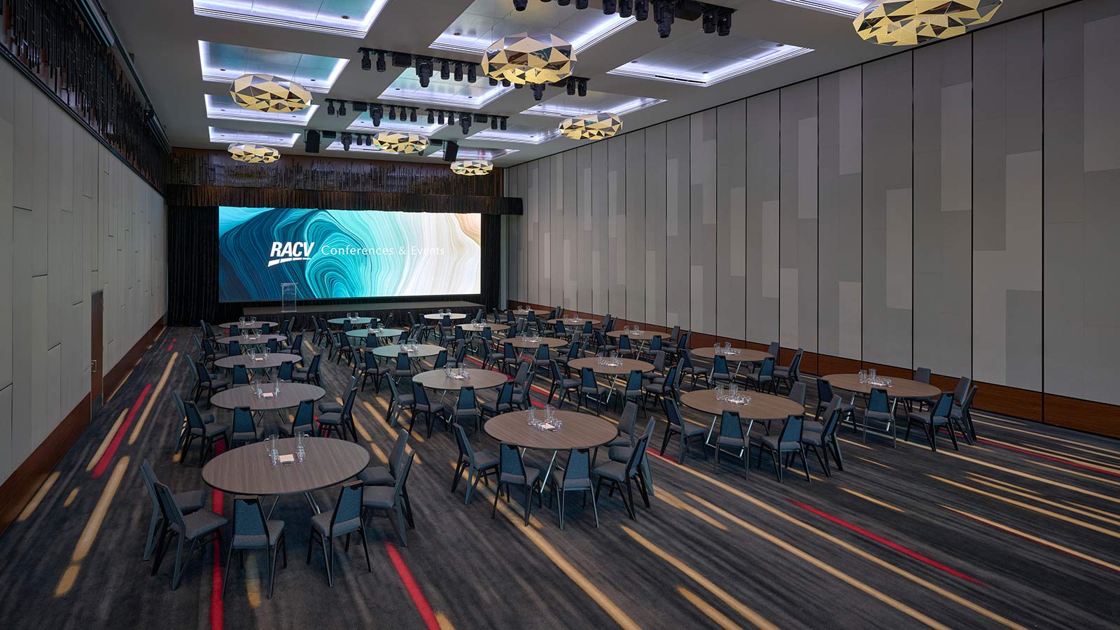 Royal Benowa Ballroom at RACV Royal Pines Resort, with a partition separating it into a smaller section that's set up cabaret style.