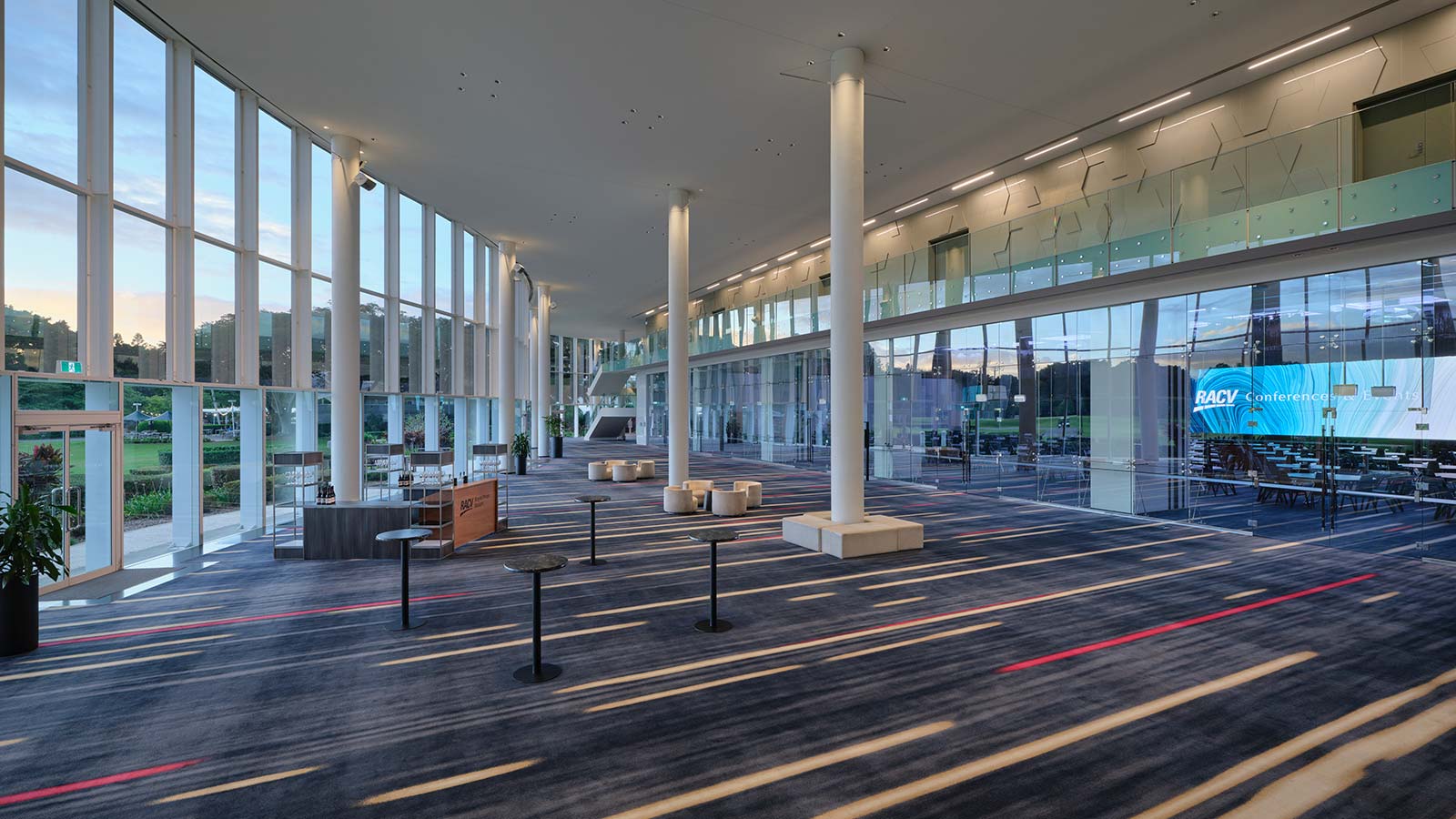 Royal Benowa Ballroom's pre-function area at RACV Royal Pines Resort, set up with four small tables and a bar.