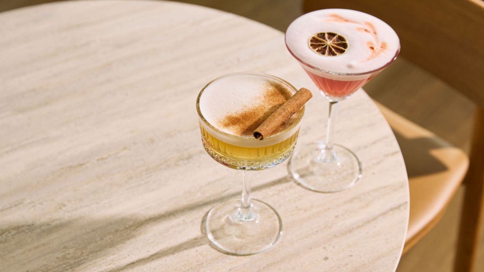Two cocktails presented on a table. 