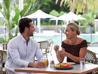 A couple enjoying breakfast outside