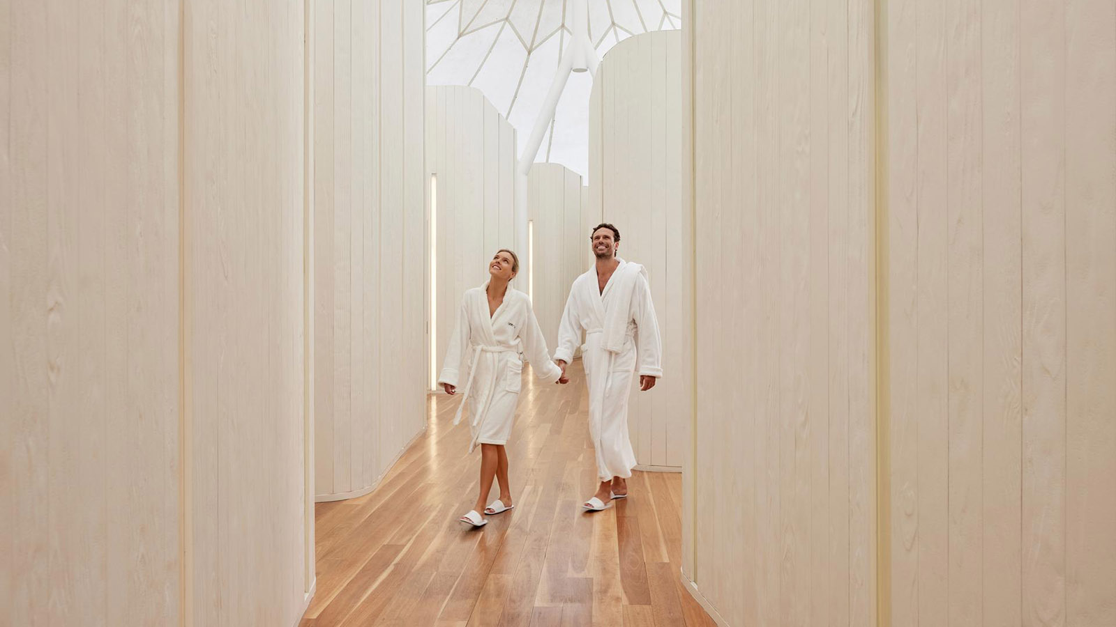 Couple holding hands and walking at the RACV Royal Pines Resort One Spa facility.