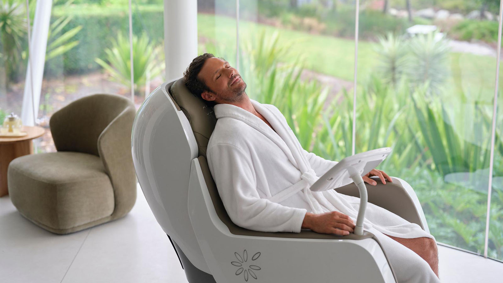 Man laying in a massage chair at the RACV Royal Pines Resort One Spa facility.