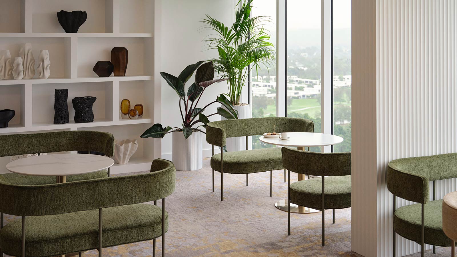 Executive Lounge at RACV Royal Pines Resort, featuring tables and chairs, and a view overlooking the resort and surrounding area.