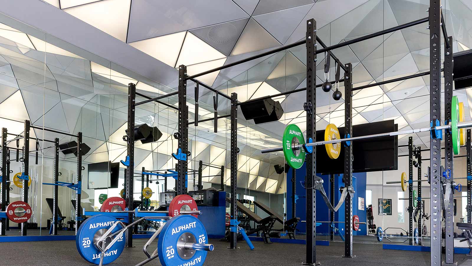 Barbells and weights in the One Lifestyle fitness centre at RACV Royal Pines Resort.