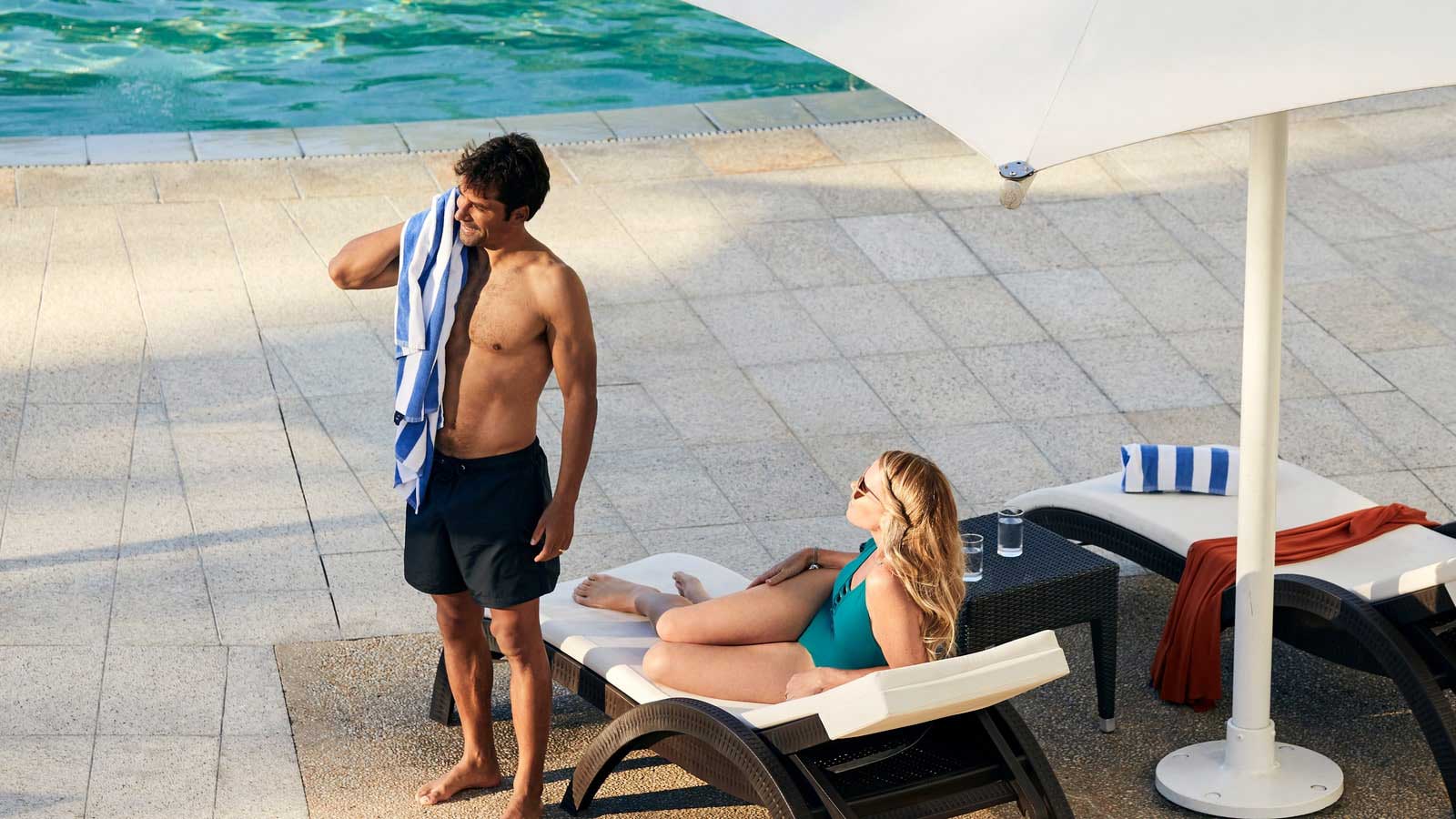 Couple drying off near the pool.