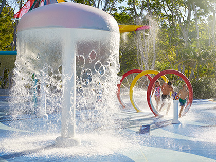 Father and two children playing in the water park at RACV Royal Pines.