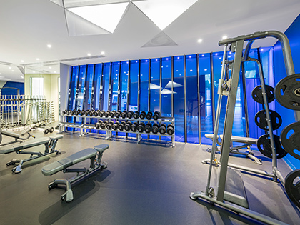 Fitness centre at RACV Royal Pines Resort, featuring weights and gym equipment.
