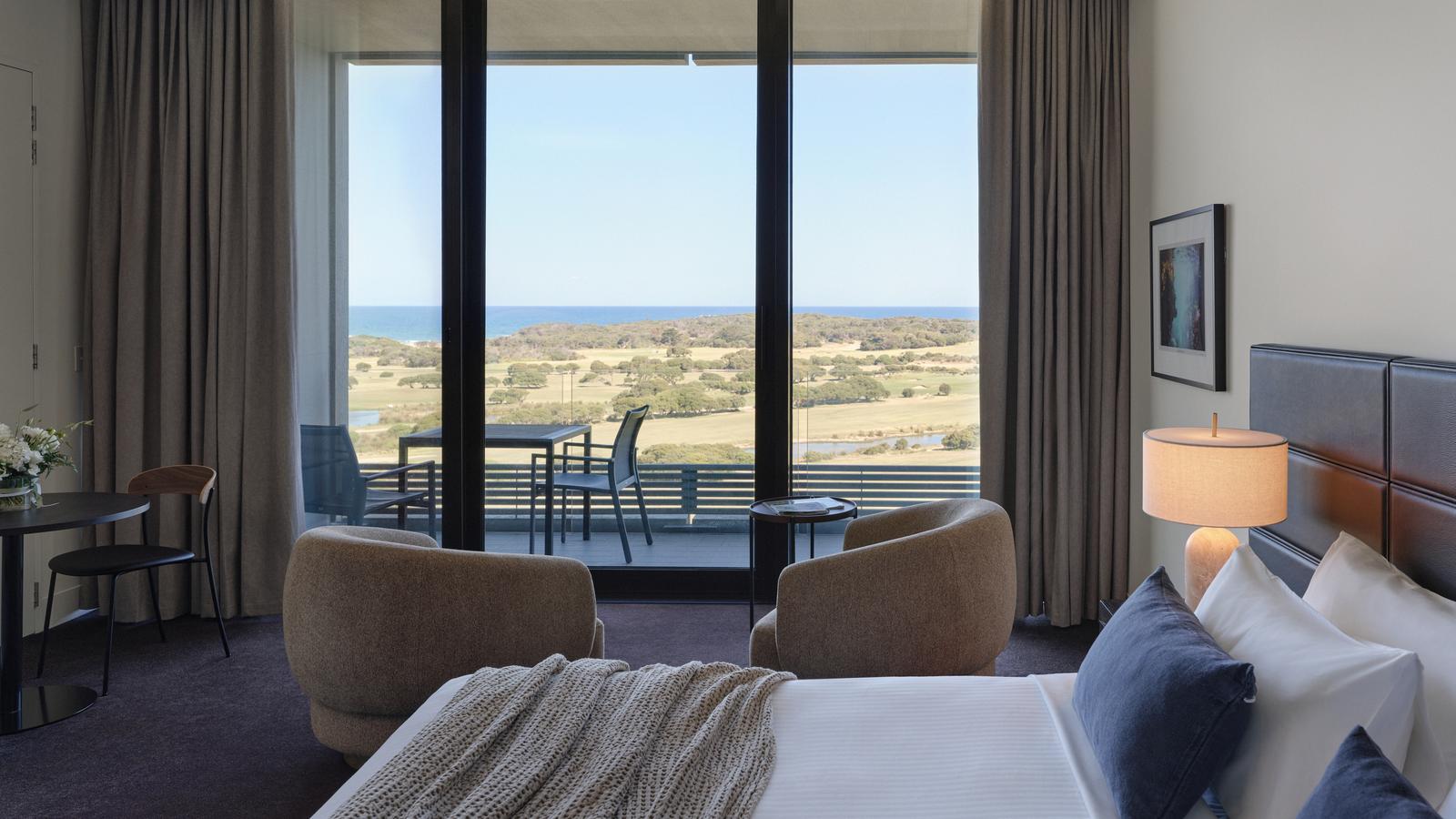 Premium ocean view room at RACV Torquay Resort, featuring a king bed, desk and couch.