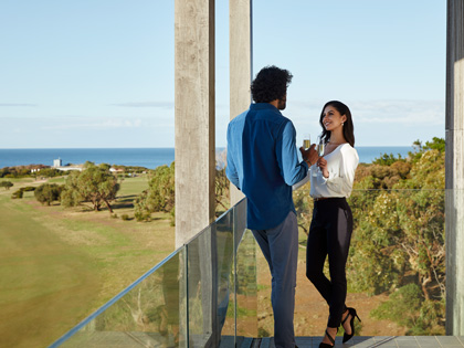 Couple having a drink together on balcony at RACV Torquay