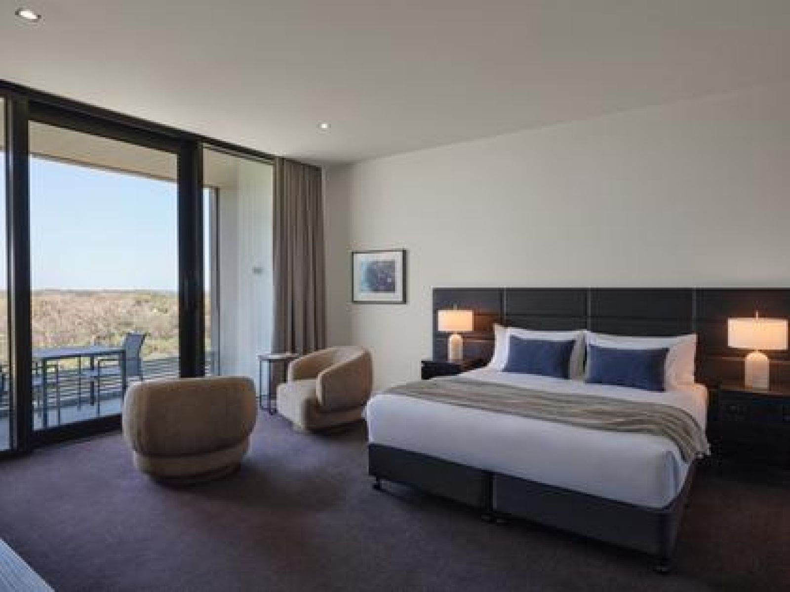 Ocean view room at RACV Torquay Resort, featuring a king bed, desk and couch.