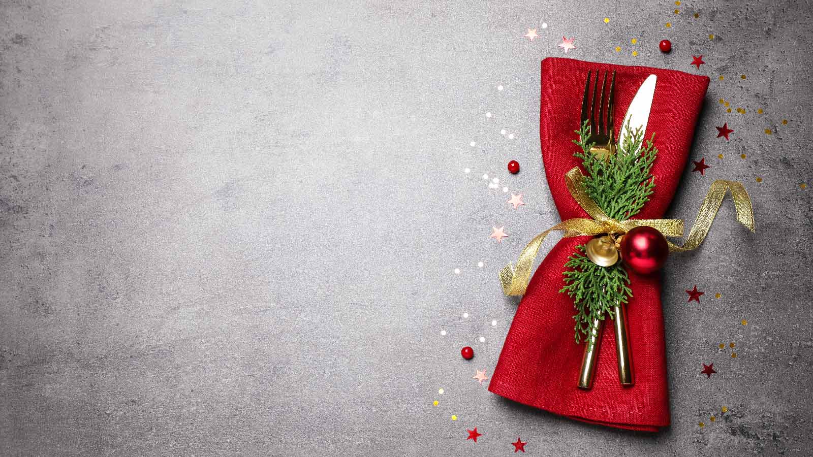 Cutlery set on grey table with christmas decor and glitter