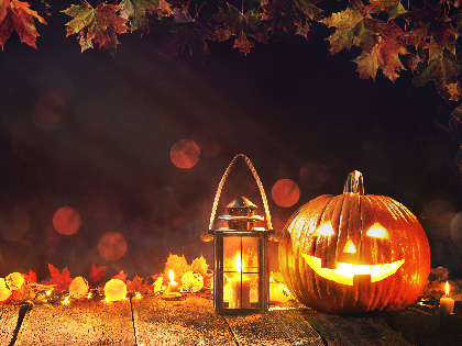 Halloween pumpkin with lantern on a wooden table