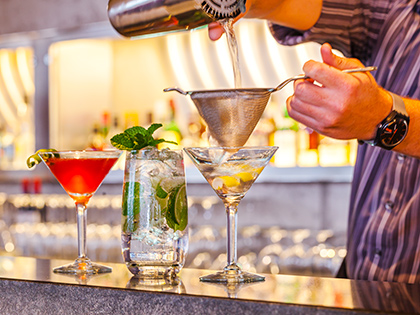 Bartender making cocktails at RACV Torquay Resort's bar.