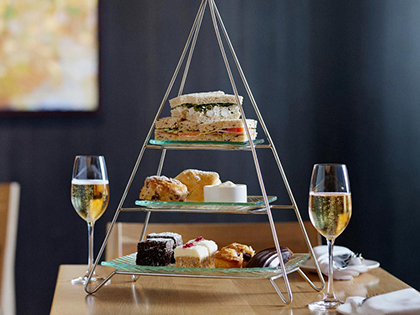Display of afternoon tea food and sparkling wine at Hardings Lounge at RACV Torquay Resort.