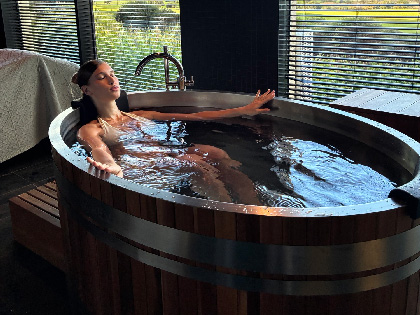 Woman soaking in a deep tob by the window. 