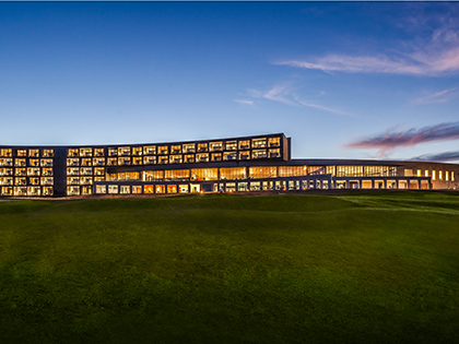 Exterior of building with lights on at dusk at RACV Torquay Resort.