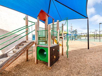 Undercover kids playground at RACV Torquay Resort, featuring a slide, small rock climbing wall and tunnel.
