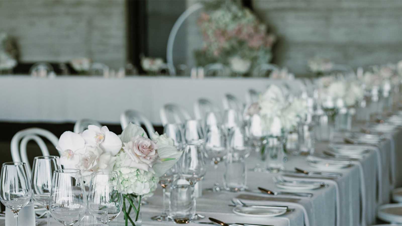 Table setting including glasswear and  pastel flower arrangements for a Torquay wedding reception.