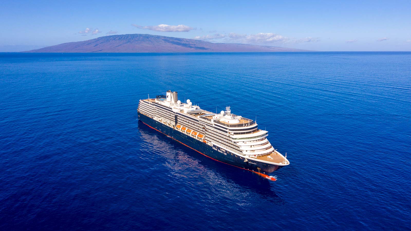 A cruise ship with a mountain in the distance.
