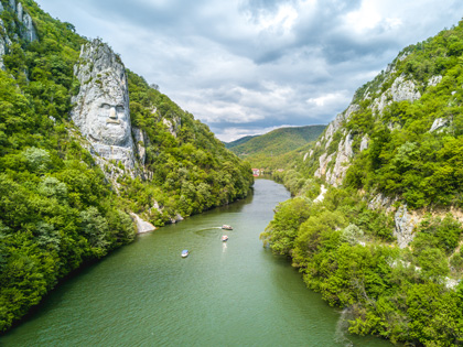 River running between two mountains with cruises going down the river