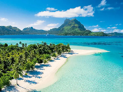 A tropical island with crystal clear waters and palm trees