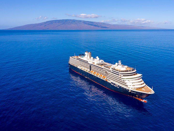 A cruise ship with a mountain in the distance.