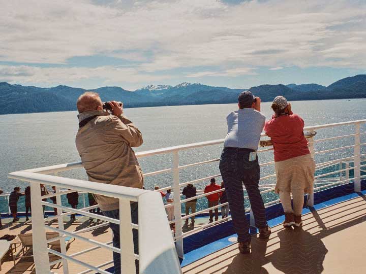 Some tourists on a deck of a ship.