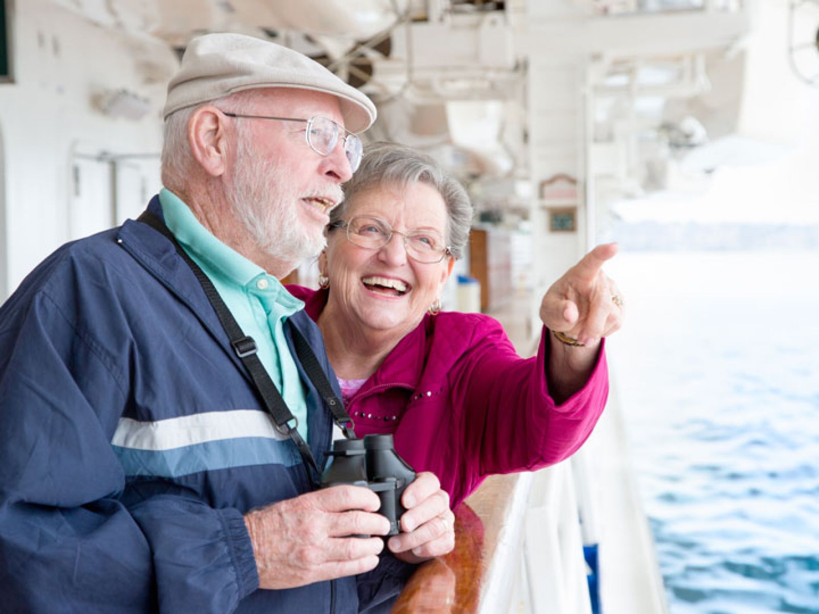 Elderly couple on a cruise together admiring the view