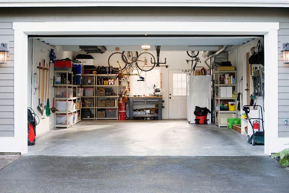 Garage with open door and expensive contents