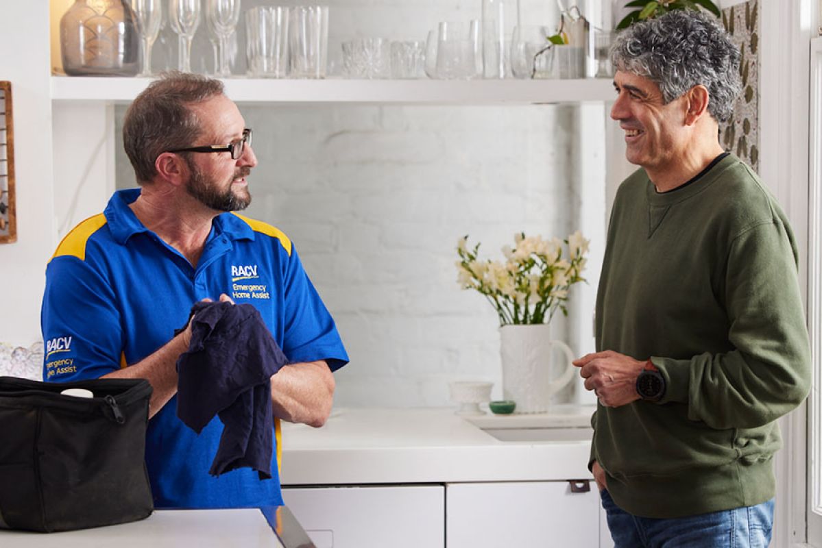 RACV tradesperson talking to a customer in their home