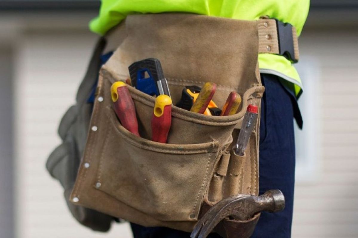 tradesman with assortment of tools in a tool belt