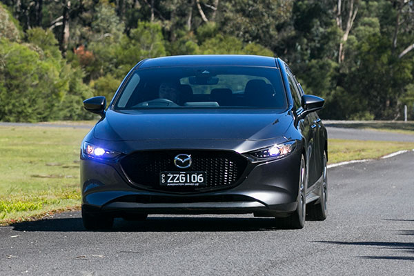Black Mazda3 G20 Evolve on test track straight