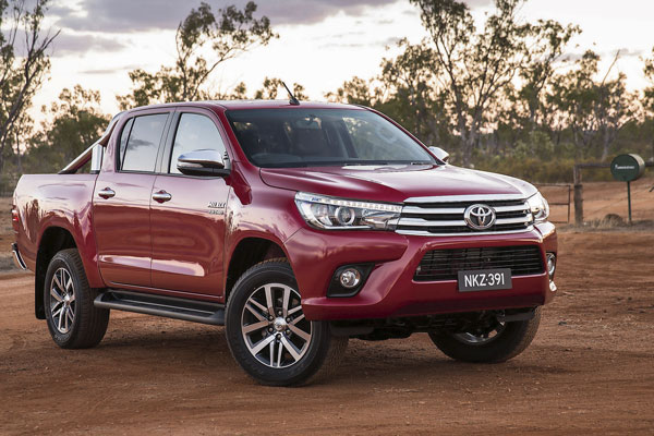 Red Toyota HiLux SR5 parked on a dirt track