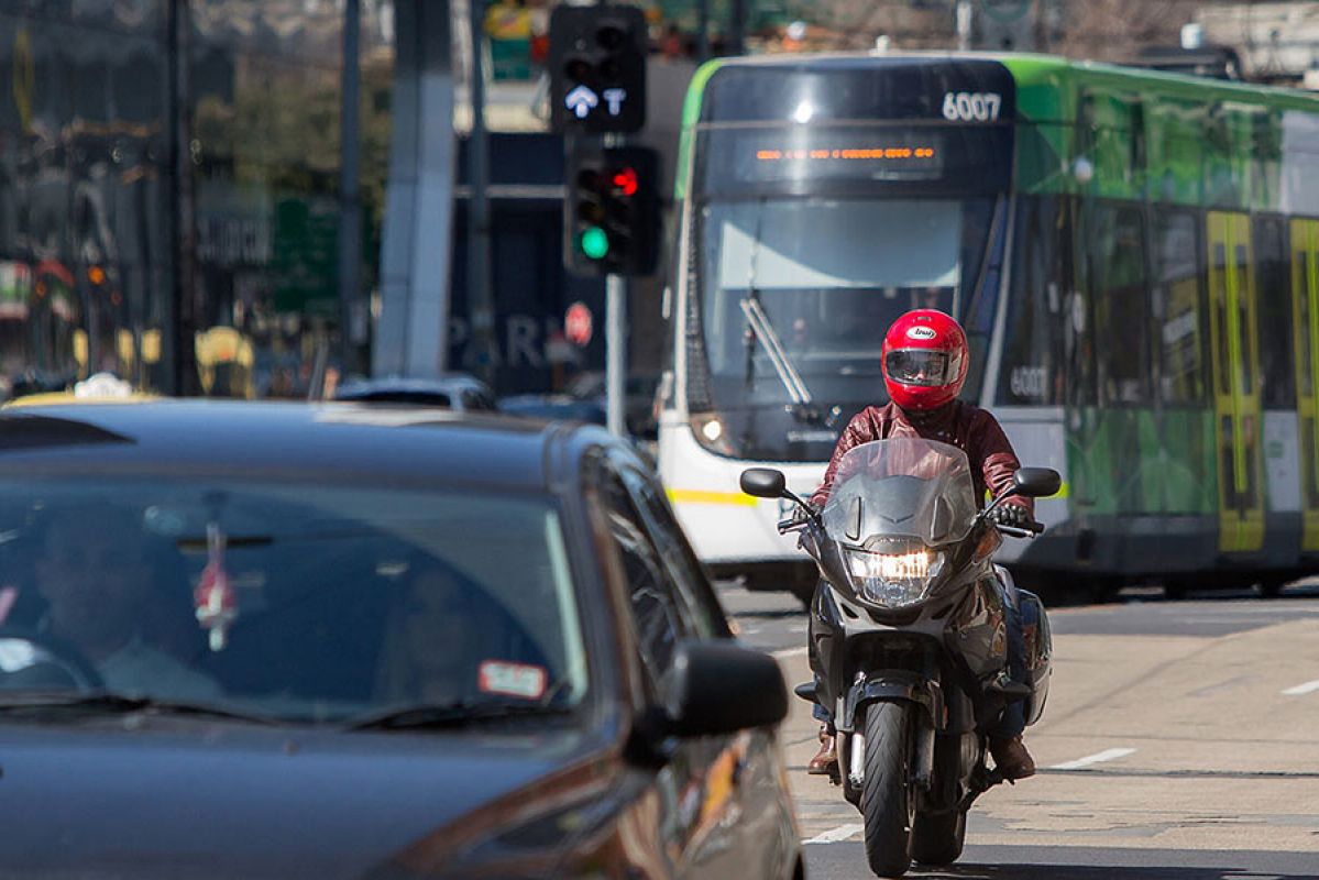 Motorbike riding through traffic in Melbourne