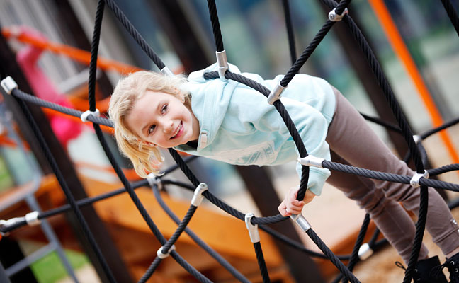 a young girl plays on a playground