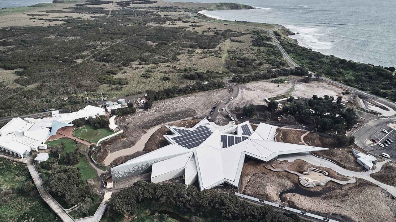 racv-solar-penguin-parade-1600x900.jpg Aerial view of geometric building fitted with solar panels at Penguin Parade.