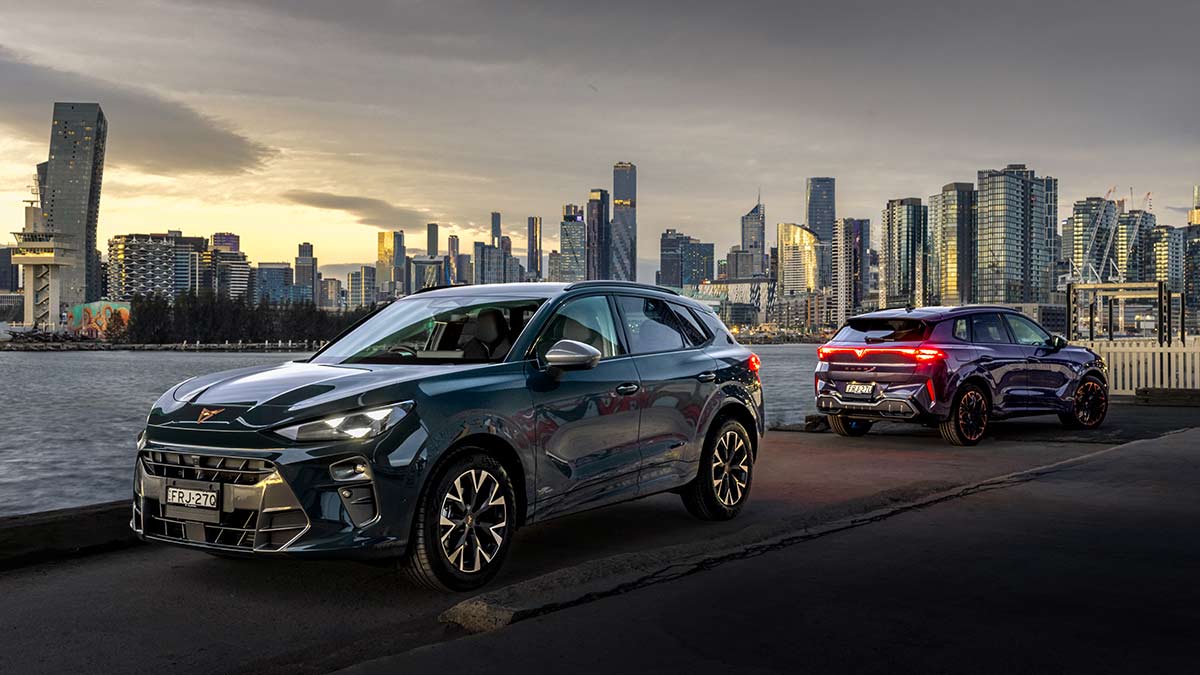Two Cupra Terramar SUVs parked on docks at Port Phillip Bay with Melbourne skyline in background