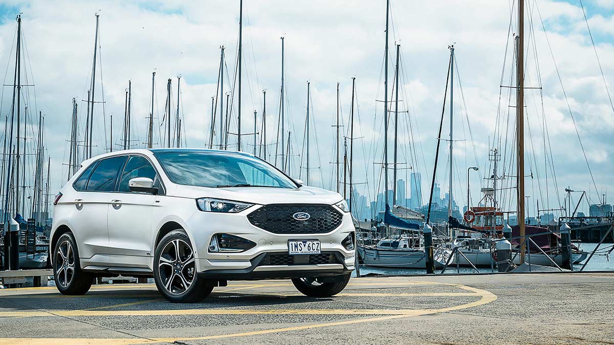Front side view of a white Ford Endura ST-Line 2019 car parked at a marina
